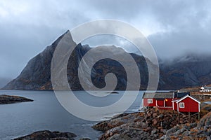 Red rorbuer and Olstinden mountain peak in background at Hamnoy fishing village