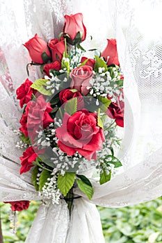 Red rose bouquet with white lace curtain