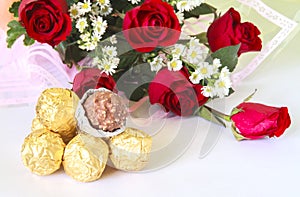 Red rose flower bouquet with chocolate ball