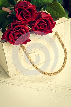 Red rose flowers on white shabby chic background