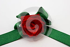 Red rose with green petals made by hand from satin ribbon