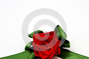 Red rose with green petals made by hand from satin ribbon