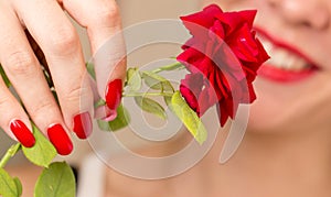 Red rose, red manicure and red lips