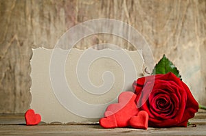 Red rose with paper for text and handemade valentines around