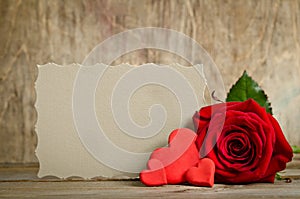 Red rose with paper for text and handemade valentines around