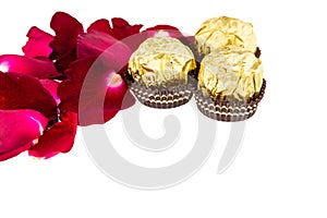 Red rose petals with Chocolate ball on white