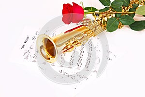 Red rose, saxophone and music sheet
