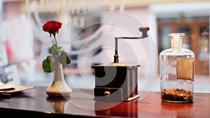 Red rose , vintage coffee grinder mill with stylish clipping path and a glass bottle with luxury coffee inside on