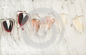 Red, rose, white wine in glasses and corkscrews, copy space