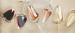 Red, rose and white wine in glasses, wide composition