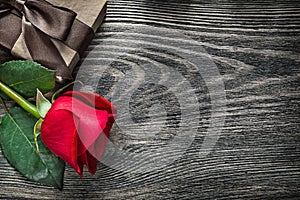 Red rose wrapped present box on wood board copy space holidays c