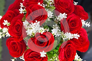 Red roses from artificial flowers and white flower