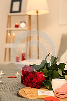 Red roses with breakfast on bed. Valentines Day celebration