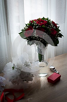 Red roses bride`s bouquet in the vase
