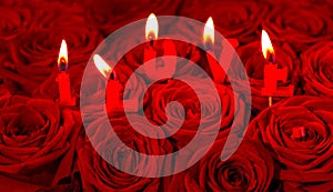 Red roses and burning candles making I LOVE