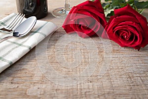 Red roses on dining table. Valentine's Day, anniversary etc.