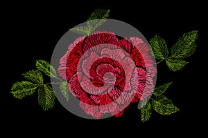 Red roses embroidery on black background. photo