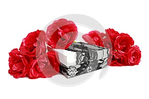 Red roses on a gift box, decorated with lace ribbon