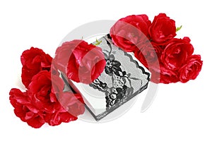 Red roses on a gift box, decorated with lace ribbon