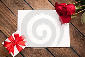 Red roses, gift box and Valentine`s day card