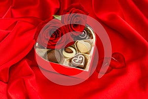Red roses with heart petals and chocolate pralines