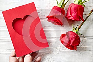 red roses and heart shaped greeting card