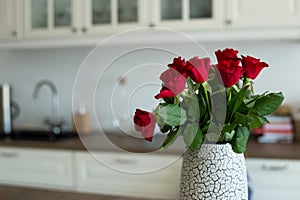 Red roses on the  kitchen table