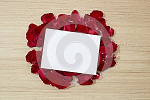 red roses petals and white blank paper