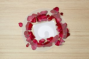 red roses petals and white blank paper