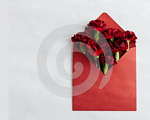 Red roses in a red envelope.