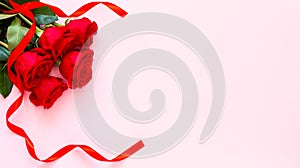 Red roses and ribbon, concept of Valentine`s, anniversary, mother`s day and birthday greeting, copy space, topview