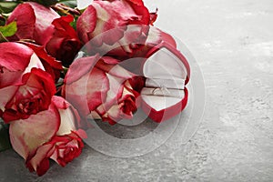 Red roses with wedding ring