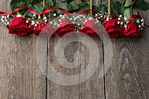 Red roses on wooden board, background, copy space