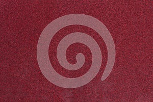 Red rough textured sandpaper background.