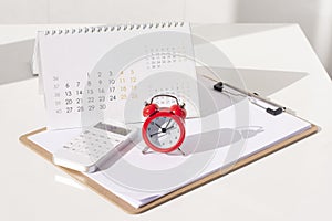 Red round alarm clock and calculator, calendar. planning concept, business concept