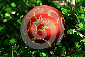 Red round fur-tree sphere on a tinsel