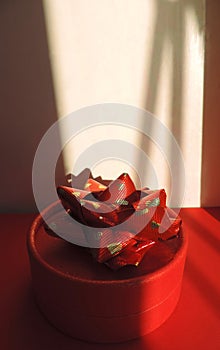 Red round gift box and Abstract geometric shadows, sunset light, stripes of light and shadow ,    sunlight pattern