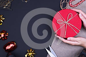 Red round gift box on black background, new year and Christmas gift wrapping,copy space