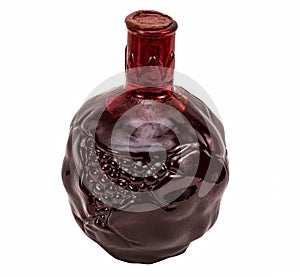 Red and round glass bottle with pomegranate wine