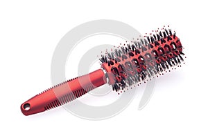 Red round hairbrush with bristle isolated on white photo