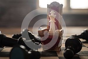 Red royal chair miniature on wooden table. Medieval Throne on chessboard. Chess board game concept of business ideas and