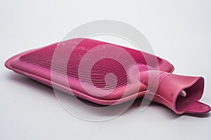 Red rubber hot water bottle against white background
