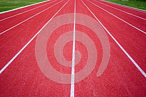 Red rubber running racetrack with white lines