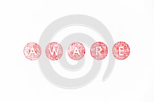 Red rubber stamp in word aware on white paper background