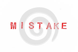 Red rubber stamp in word mistake on white paper background