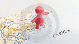 A red rubber toy woman overlooking Ayia Napa on a map of Cyprus