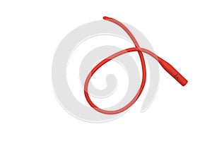 red rubber urethral catheter on white background photo