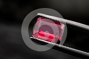 Red ruby gemstone with dark rock