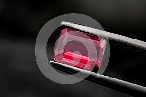 Red ruby gemstone with dark rock photo