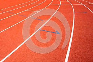 Red running track on athletic stadium